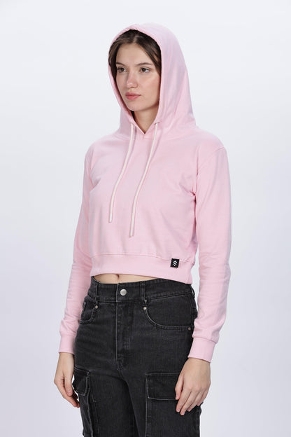 Soulmonk soft pink crop hoodie worn by female model with hood up and black cargo pants