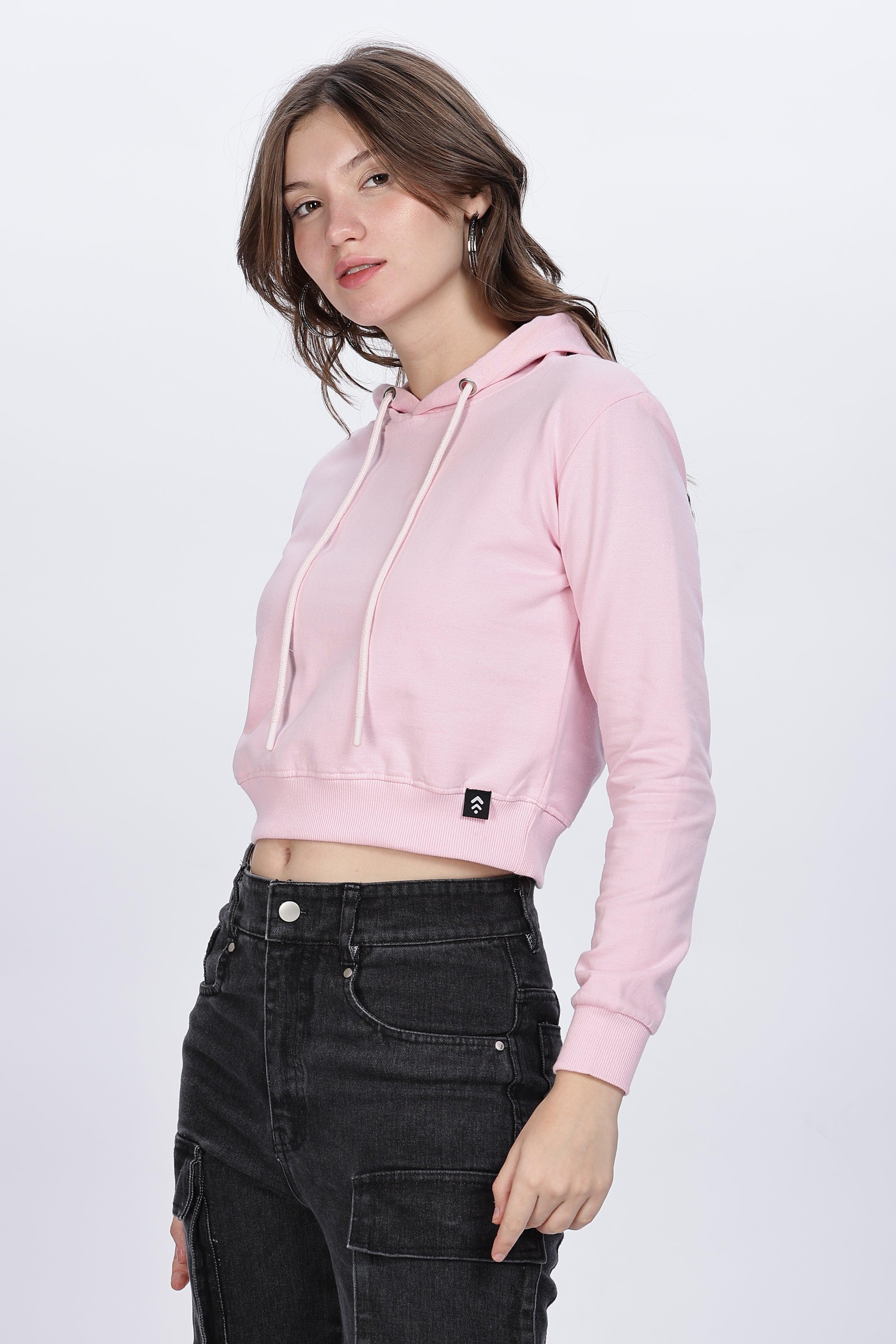 Soulmonk soft pink crop hoodie worn by female model with black high-waisted pants