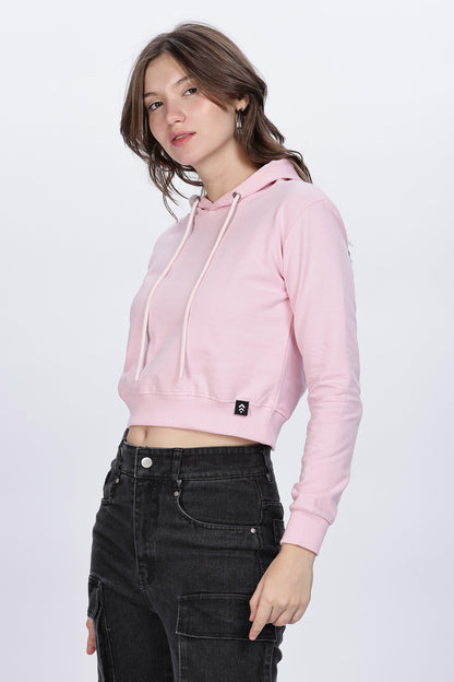 Soulmonk soft pink crop hoodie worn by female model with black high-waisted pants