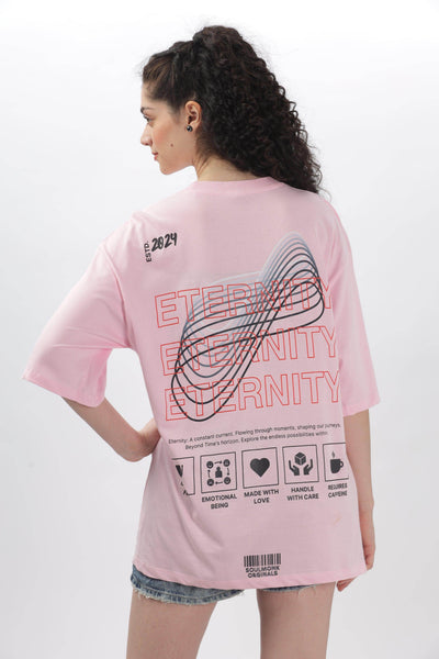 Woman wearing Soulmonk soft pink oversized t-shirt with graphic print on back and denim shorts