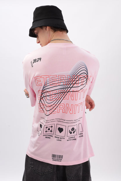 Male model wearing a Soulmonk soft pink oversized t-shirt with graphic back design and black bucket hat