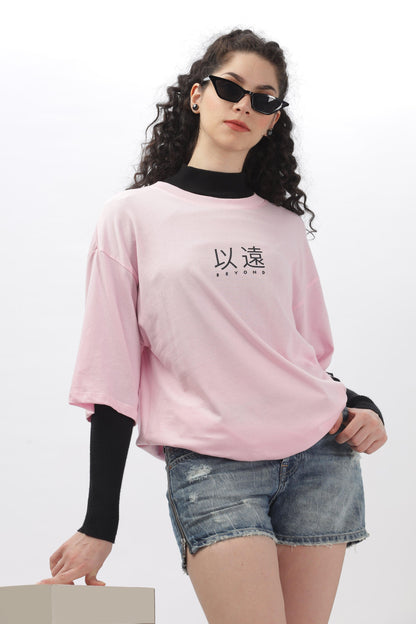 Soulmonk soft pink oversized t-shirt worn by female model with black sunglasses and denim shorts
