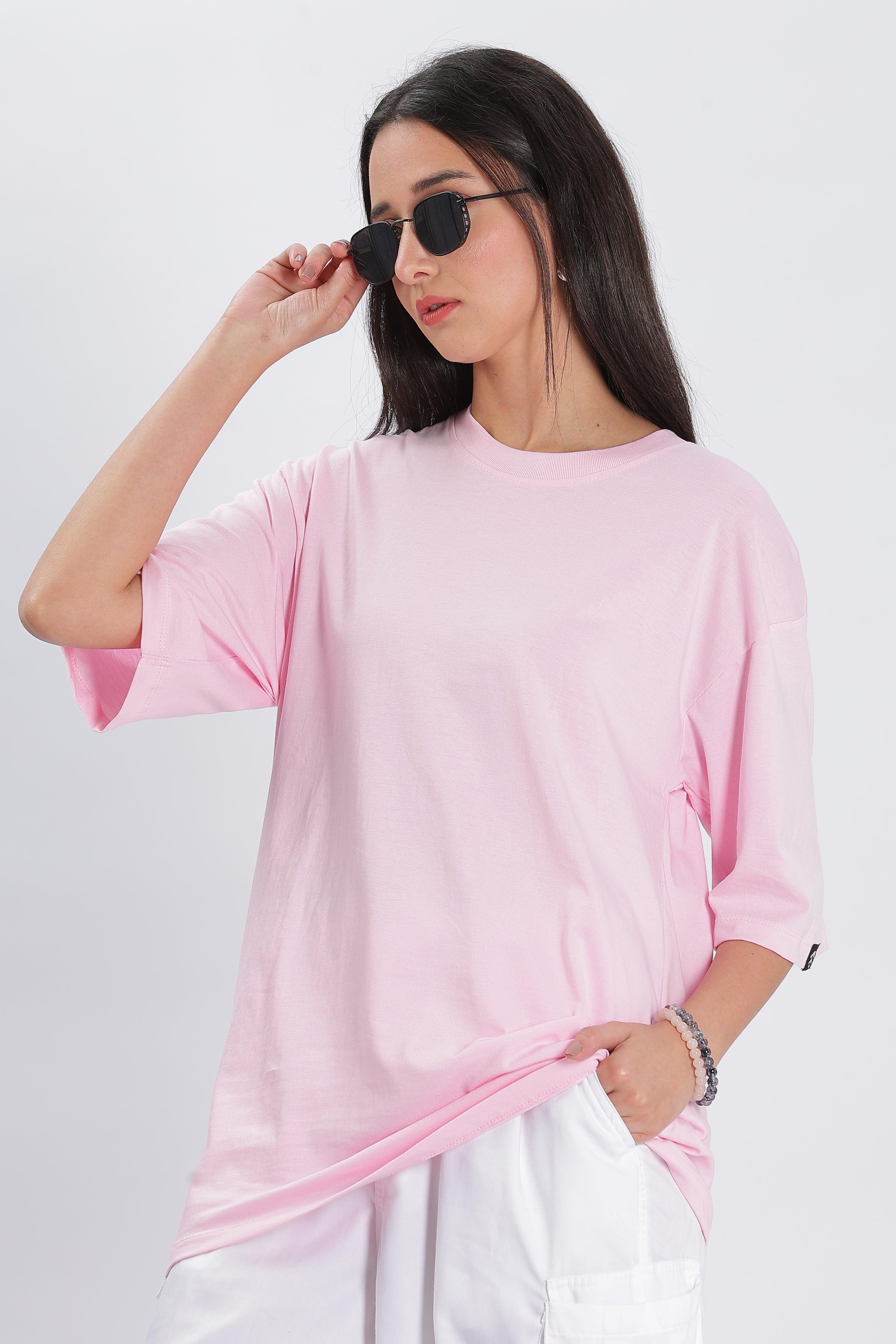 Soulmonk soft pink oversized t-shirt worn by female model with sunglasses and white pants