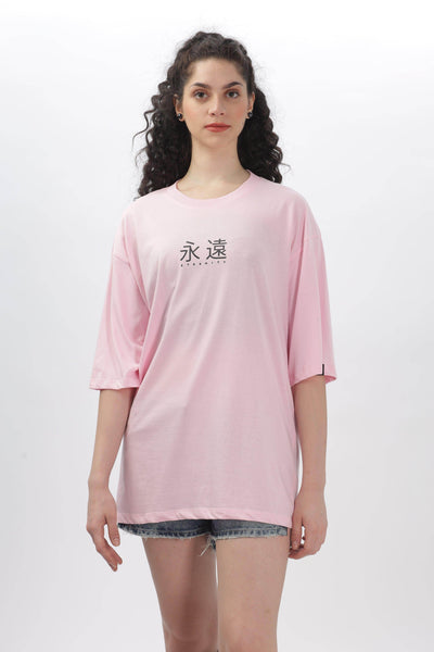 Female model wearing Soulmonk soft pink oversized t-shirt with black graphic text on front