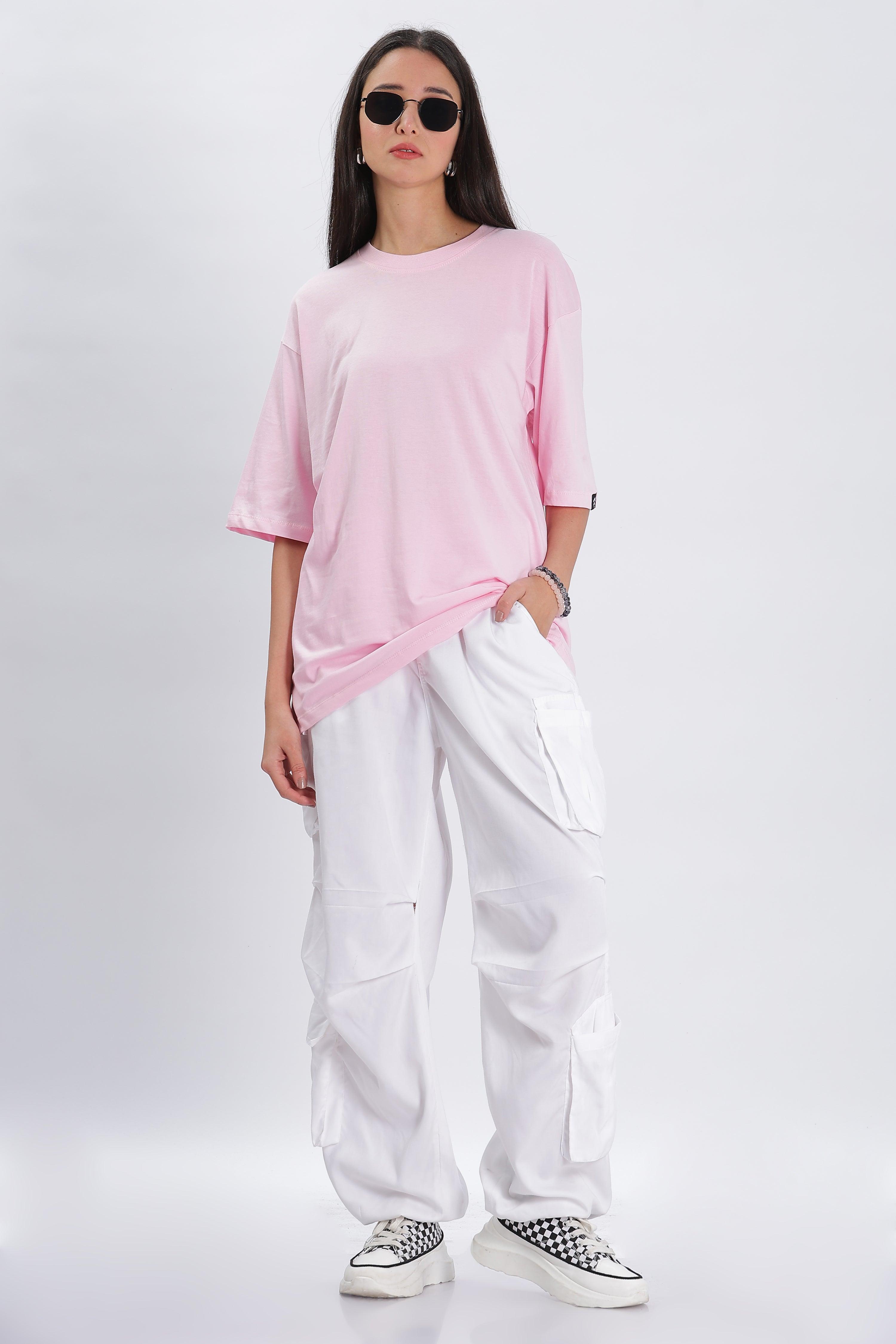 Soulmonk soft pink oversized t-shirt worn by female model with white cargo pants and sunglasses