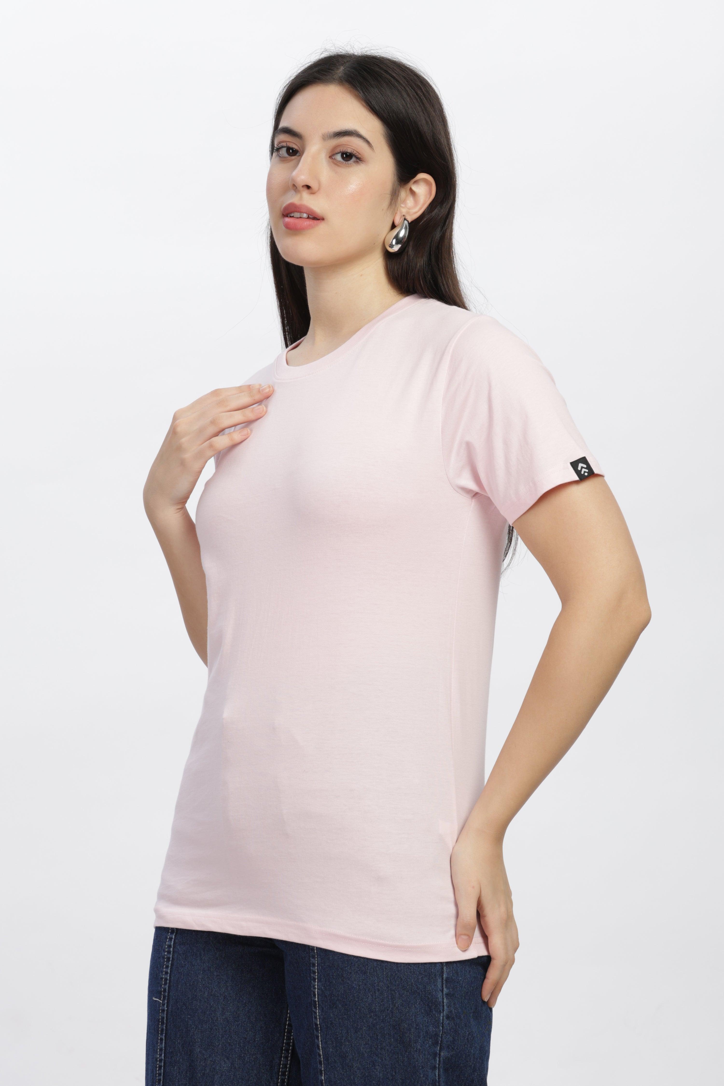 Woman wearing soft pink relaxed fit t-shirt by Soulmonk paired with dark jeans