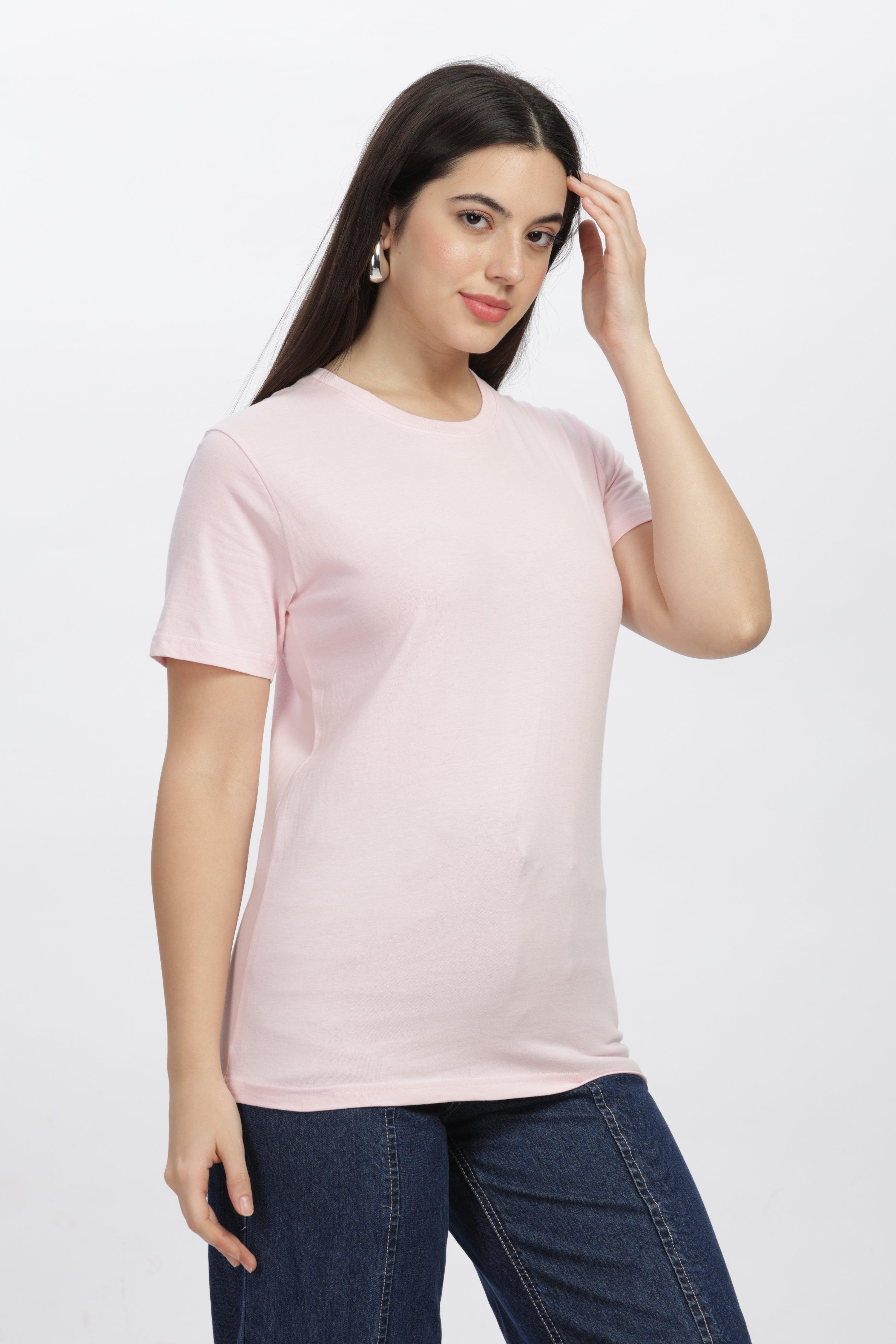 Female model wearing a soft pink relaxed fit t-shirt paired with blue jeans by Soulmonk