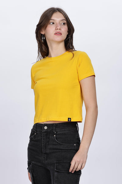 Soulmonk soft yellow crop top worn by female model with black cargo pants