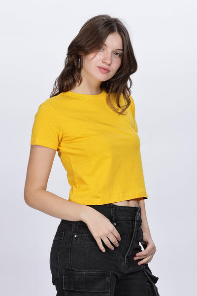 Soulmonk soft yellow crop top worn by female model with black pants in studio