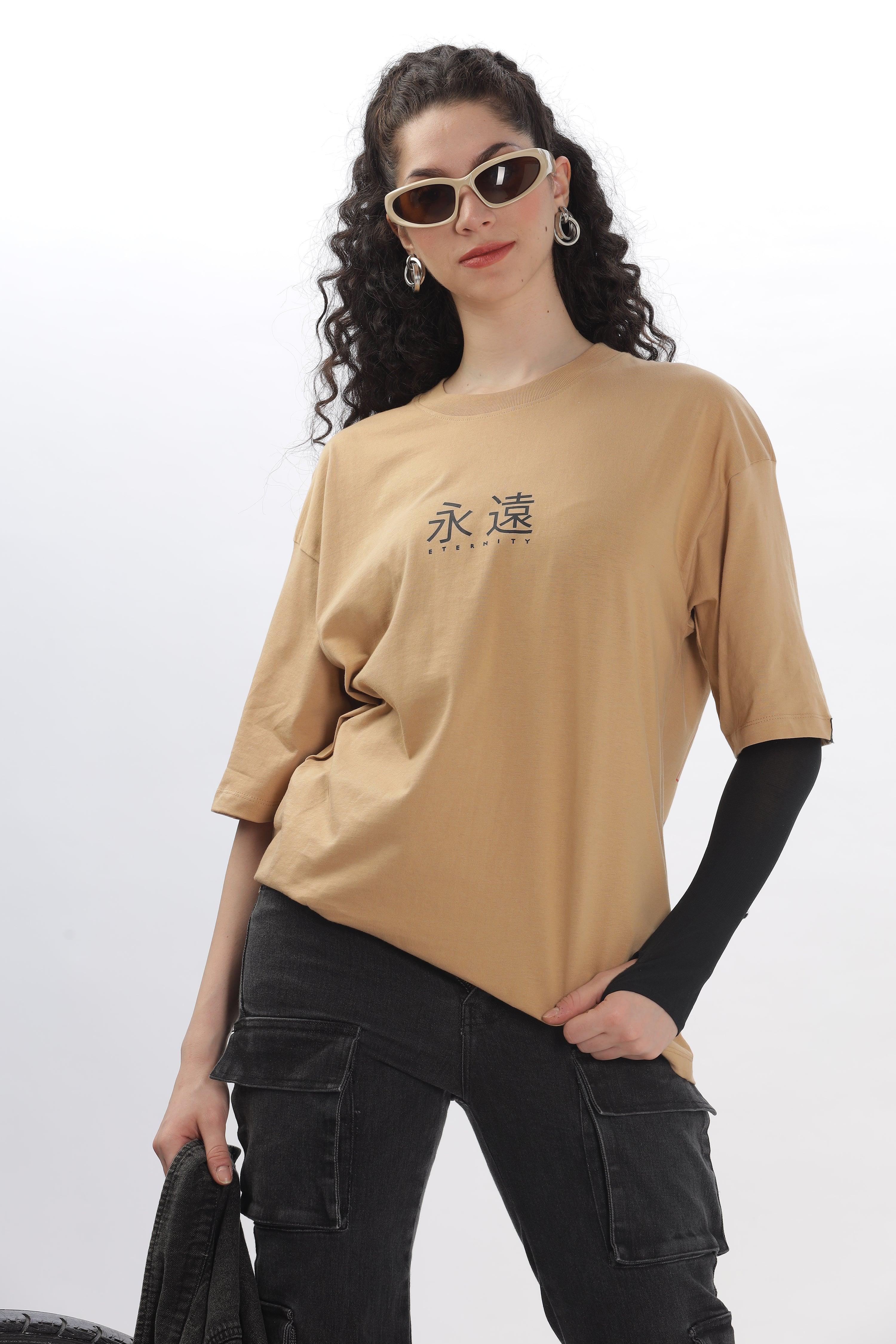 Soulmonk taupe oversized t-shirt with black Japanese text worn by woman with curly hair and sunglasses