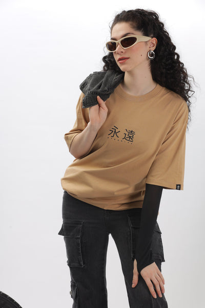 Soulmonk taupe oversized t-shirt worn by female model with black pants and sunglasses
