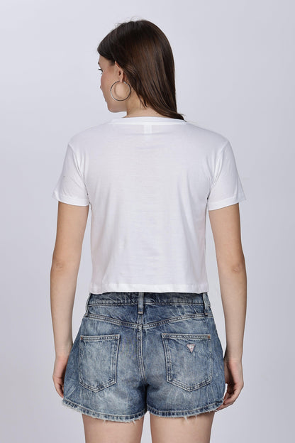 Back view of female wearing Soulmonk white crop top for women paired with denim shorts